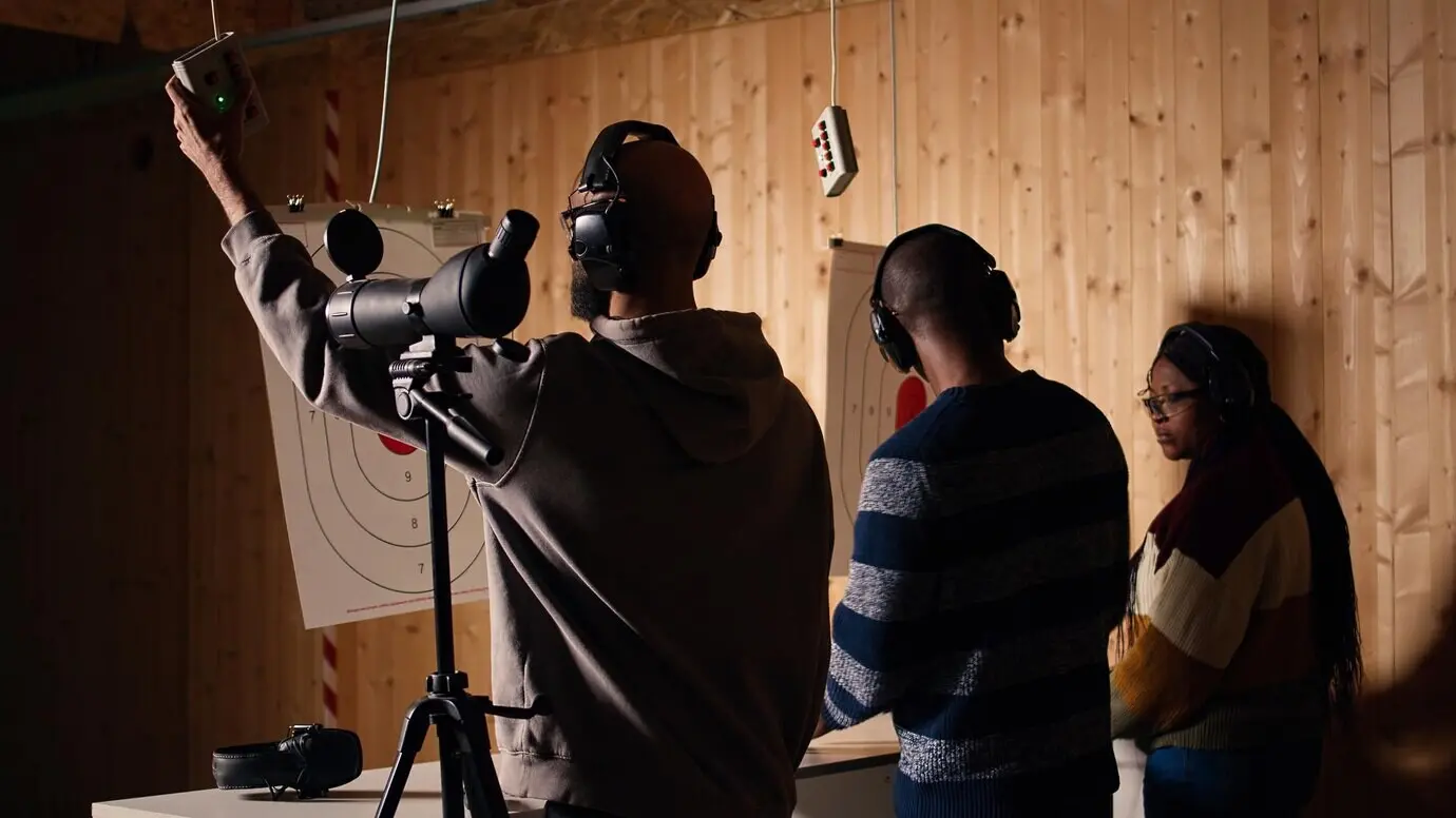 Freunde am Schießstand schießen und zoomen heran, um die auf den Bullseyes erzielten Punkte zu überprüfen.